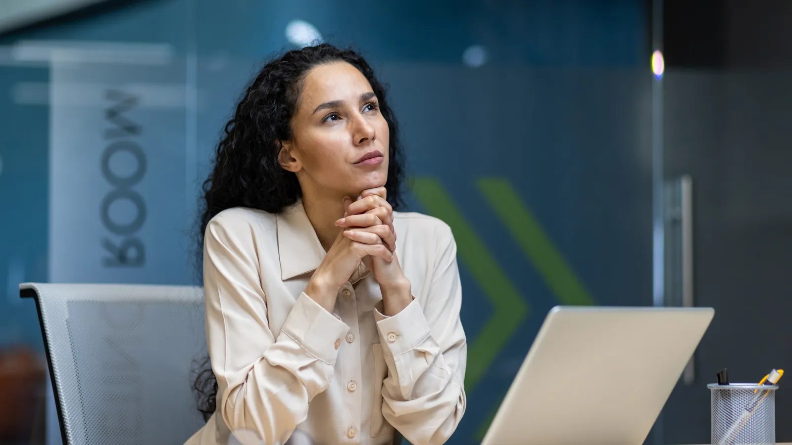 Woman at a laptop thinking about her career goals