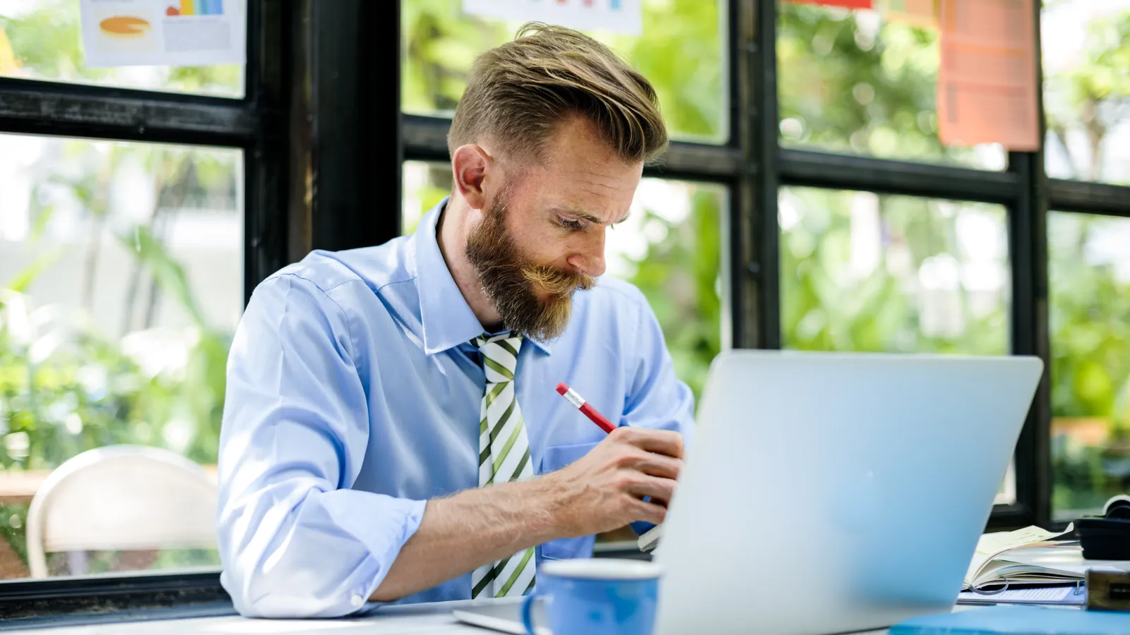 Self-employed man working on his website on a laptop