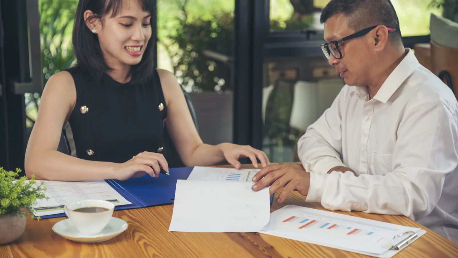 Business owner and consultant reviewing documents together