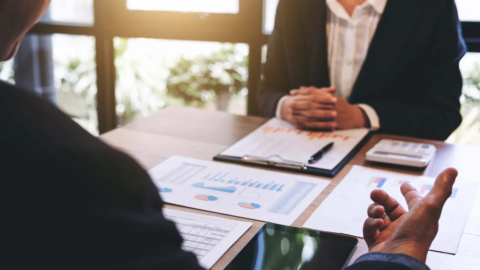 Key figures and charts on the table during a business consultation