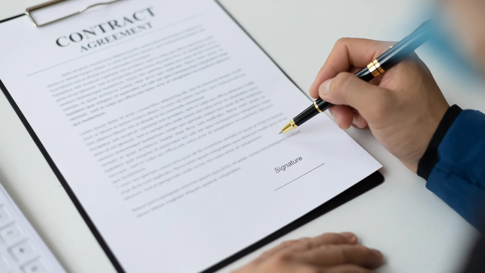 Signing a contract with a fountain pen